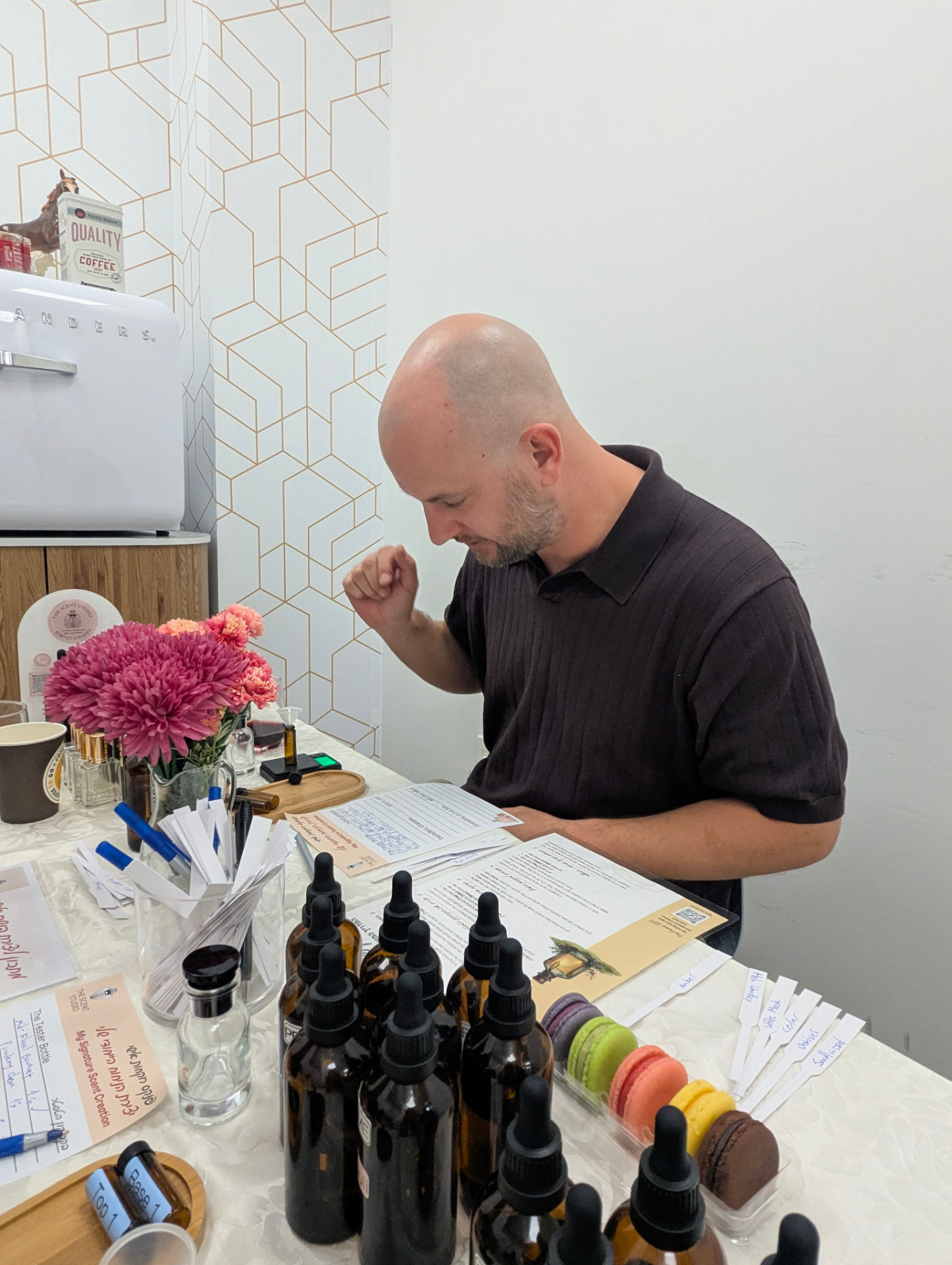 A guest blending a personal perfume at the real studio table